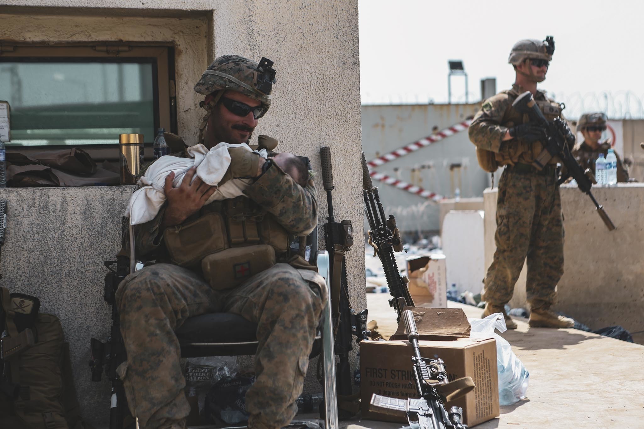 US Marine takes care of baby during evacuation of Kabul airport