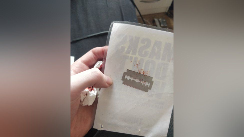 Woman injured after removing anti-vax poster with hidden razor