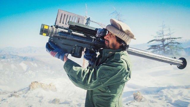 A Mujaheddin fighter aims a Stinger Missile at a passing Soviet Aircraft, Nangarhār Province, Afghanistan. 1988