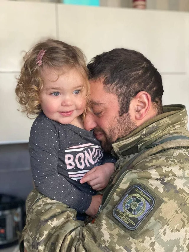 Ukrainian soldier gives a hug to his daughter. Fight for freedom, Stand with Ukraine.
