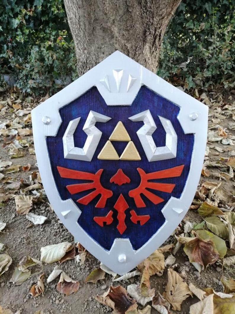 Hylian Shield from Legend Of Zelda. I crafted it out of wood and finished with acrylic paint. Hope you guys liked it.