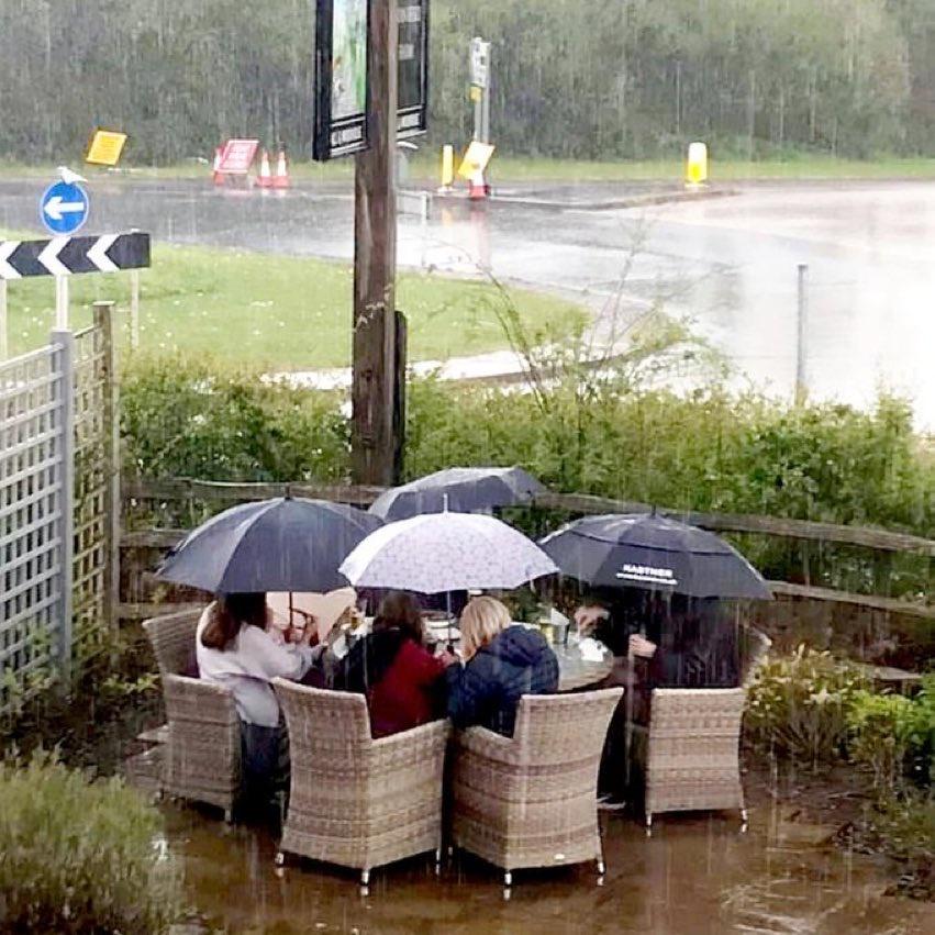 The single most British thing you'll see today, alfresco dining in the rain, next to a roundabout.